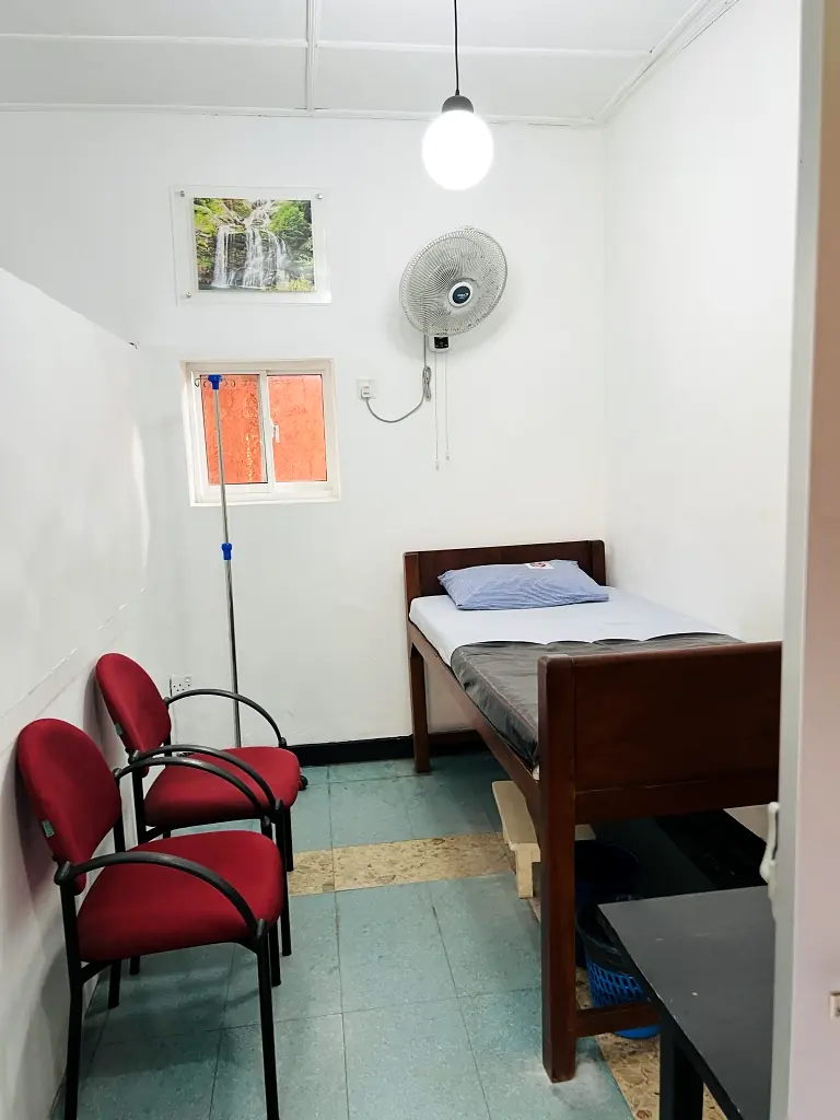 Private patient room with bed and visitor chair