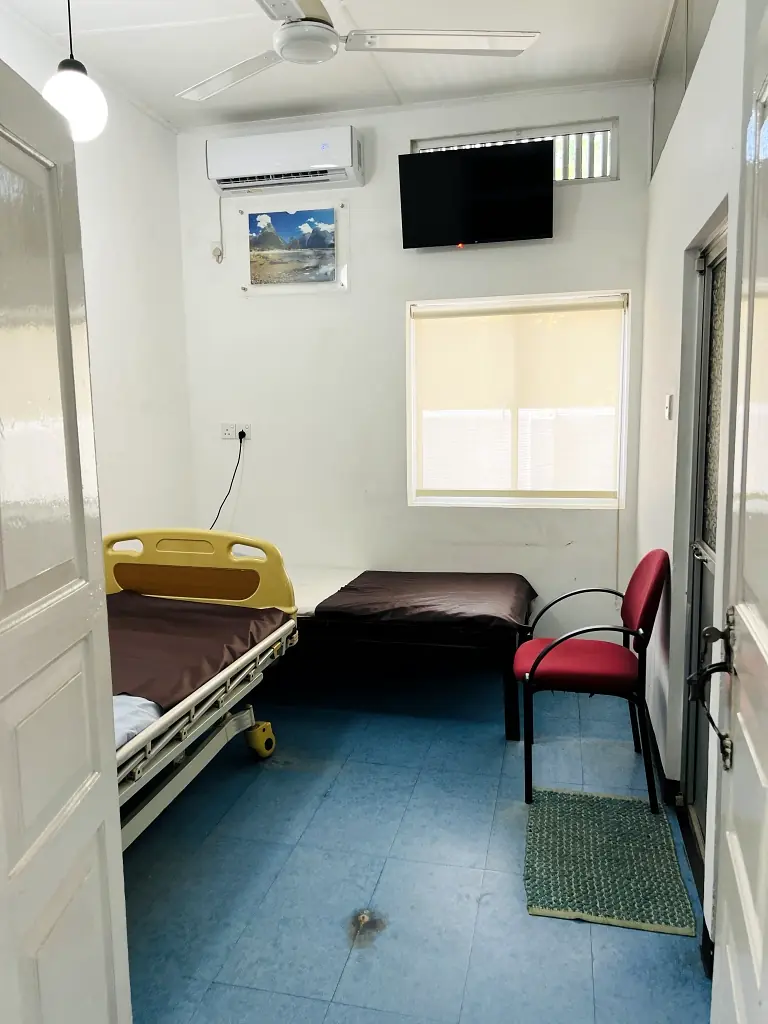 Clean private patient room at Central Nursing Home