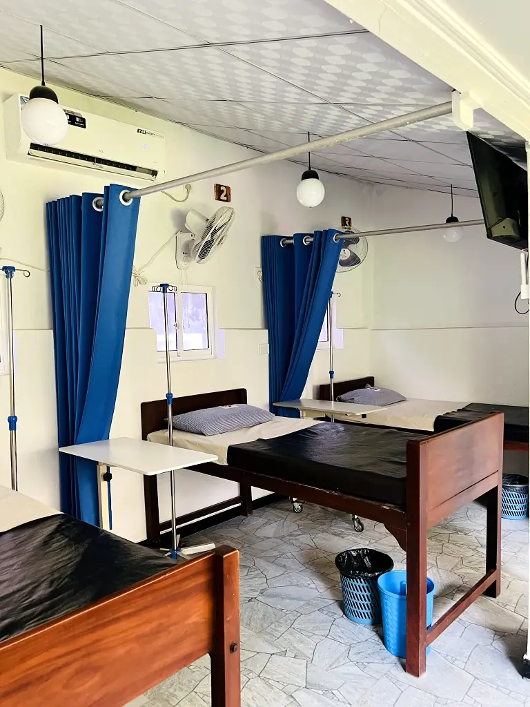 Ward beds with privacy curtains at Central Nursing Home